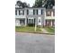 Charming townhome featuring a well-maintained lawn, neutral siding, and black shutters at 2880 Aspen Woods Entry, Doraville, GA 30360