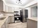 Modern kitchen featuring stainless steel appliances, gray cabinets, and granite countertops at 2880 Aspen Woods Entry, Doraville, GA 30360