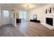 Bright living room boasts a fireplace, modern lighting, and wood-look floors at 2880 Aspen Woods Entry, Doraville, GA 30360