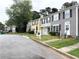 Charming street view featuring well-maintained townhomes and mature trees at 2880 Aspen Woods Entry, Doraville, GA 30360