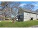 This backyard features a large grassy area, mature trees, and a deck with stairs to the ground at 3087 Semmes St, Atlanta, GA 30344
