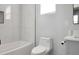 Modern bathroom featuring white marbled tiles, a bathtub, and updated fixtures at 3087 Semmes St, Atlanta, GA 30344