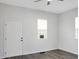Well-lit bedroom featuring two windows, a ceiling fan, and a white door at 3087 Semmes St, Atlanta, GA 30344