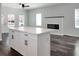 Open-concept living area with modern fireplace and kitchen island at 3087 Semmes St, Atlanta, GA 30344