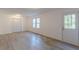 Finished basement with new flooring, natural light, and exterior access offers potential as a rec room or additional living space at 4639 Hardwood Rd, Stone Mountain, GA 30083