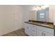 Bathroom featuring a double sink vanity with quartz countertops, large mirror and modern lighting at 4639 Hardwood Rd, Stone Mountain, GA 30083