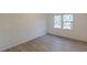 This bedroom features sleek hardwood floors and a window for natural light at 4639 Hardwood Rd, Stone Mountain, GA 30083