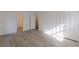Bedroom with wood-look flooring, white walls, and closet with white doors at 4639 Hardwood Rd, Stone Mountain, GA 30083