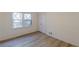This bedroom features sleek hardwood floors, closet and a window for natural light at 4639 Hardwood Rd, Stone Mountain, GA 30083