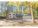 Exterior view showcasing the house with a two car garage, encircled by a lush array of trees, offering both shade and beauty at 4639 Hardwood Rd, Stone Mountain, GA 30083