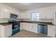 Modern kitchen with stainless steel appliances, sleek countertops, and white cabinets at 4639 Hardwood Rd, Stone Mountain, GA 30083