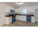 Well-equipped kitchen with modern appliances, sleek countertops, and ample storage space in white cabinets at 4639 Hardwood Rd, Stone Mountain, GA 30083
