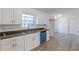 Modern kitchen with white cabinets, sleek countertops, stainless steel appliances, and new flooring at 4639 Hardwood Rd, Stone Mountain, GA 30083
