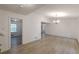 Spacious living area with sleek, light colored floors, complemented by neutral walls and contemporary chandelier at 4639 Hardwood Rd, Stone Mountain, GA 30083