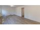 Spacious living room with light wood floors, a door and neutral walls at 4639 Hardwood Rd, Stone Mountain, GA 30083