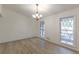 Inviting room with modern flooring, complemented by a contemporary light fixture and windows offering scenic outdoor views at 4639 Hardwood Rd, Stone Mountain, GA 30083