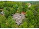 Aerial view of a beautiful home with a multi-story deck surrounded by mature trees provides privacy at 8345 Jett Ferry Rd, Sandy Springs, GA 30350
