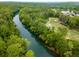 Aerial view of a river and golf course provides a beautiful and recreational scene for nearby homes at 8345 Jett Ferry Rd, Sandy Springs, GA 30350
