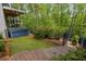 Backyard has a small lawn and wooden stairs lead from the multi-story deck into the trees at 8345 Jett Ferry Rd, Sandy Springs, GA 30350