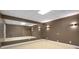 Bright basement features large mirrors and neutral carpet, perfect for a home gym at 8345 Jett Ferry Rd, Sandy Springs, GA 30350