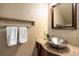 Chic powder room with vessel sink, modern vanity, and decorative tile accent at 8345 Jett Ferry Rd, Sandy Springs, GA 30350