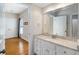Bright bathroom featuring white cabinets, granite counters, and an attached room at 8345 Jett Ferry Rd, Sandy Springs, GA 30350