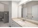 Clean bathroom with white cabinets, granite counters, and tile flooring at 8345 Jett Ferry Rd, Sandy Springs, GA 30350