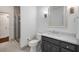 Bathroom features a gray vanity with a white marble countertop and a walk-in shower at 8345 Jett Ferry Rd, Sandy Springs, GA 30350