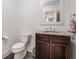 Cozy bathroom features a granite vanity, a toilet, and modern fixtures at 8345 Jett Ferry Rd, Sandy Springs, GA 30350
