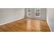 Bright bedroom with hardwood floors and two windows offering a serene view at 8345 Jett Ferry Rd, Sandy Springs, GA 30350