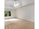 Spacious primary bedroom featuring a ceiling fan and natural light from the window at 8345 Jett Ferry Rd, Sandy Springs, GA 30350