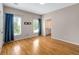 Neutral bedroom featuring hardwood floors, ample natural light, and an adjoining bathroom at 8345 Jett Ferry Rd, Sandy Springs, GA 30350