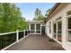 Large deck with black railing and beautiful screened-in porch perfect for enjoying nature at 8345 Jett Ferry Rd, Sandy Springs, GA 30350