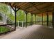 Wooden deck with stairs features dark wood beams and open views into the surrounding wooded landscape at 8345 Jett Ferry Rd, Sandy Springs, GA 30350