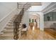Elegant foyer with staircase and beautiful tile flooring, leading to the living spaces at 8345 Jett Ferry Rd, Sandy Springs, GA 30350