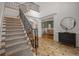 Spacious foyer featuring a staircase with iron railing, decorative tile flooring, and views to the dining room at 8345 Jett Ferry Rd, Sandy Springs, GA 30350