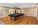 Open concept game room includes pool table, bar area and hardwood flooring at 8345 Jett Ferry Rd, Sandy Springs, GA 30350