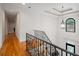 Elegant hallway with decorative window, detailed railing, and hardwood floors at 8345 Jett Ferry Rd, Sandy Springs, GA 30350
