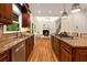 Chef's kitchen with an island, granite countertops, modern appliances, and an open concept to the living area at 8345 Jett Ferry Rd, Sandy Springs, GA 30350