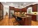 Gourmet kitchen features a large island with seating, stainless appliances, and custom wood cabinets at 8345 Jett Ferry Rd, Sandy Springs, GA 30350