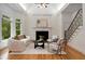 Bright living room with fireplace, natural light, and staircase, perfect for relaxing or entertaining guests at 8345 Jett Ferry Rd, Sandy Springs, GA 30350