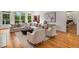Bright living room with hardwood floors, large windows, and a comfortable seating arrangement at 8345 Jett Ferry Rd, Sandy Springs, GA 30350