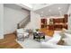 Open-concept living space features a cozy living room that flows into the kitchen with hardwood floors at 8345 Jett Ferry Rd, Sandy Springs, GA 30350