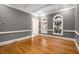 Refined living area with tray ceiling, hardwood flooring, and trim accents around the room at 8345 Jett Ferry Rd, Sandy Springs, GA 30350