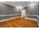 Stylish living area with tray ceiling, hardwood flooring, and trim accents around the room at 8345 Jett Ferry Rd, Sandy Springs, GA 30350