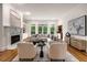 Bright living room with fireplace, hardwood floors, comfortable seating arrangement, and built-in bar at 8345 Jett Ferry Rd, Sandy Springs, GA 30350