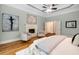 Well-lit main bedroom with hardwood floors, a fireplace, and comfortable seating area at 8345 Jett Ferry Rd, Sandy Springs, GA 30350