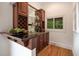 A sophisticated wet bar area with custom cabinetry, wine storage, and a sink at 8345 Jett Ferry Rd, Sandy Springs, GA 30350