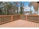 Large wooden deck with decorative railing, offering an inviting outdoor space surrounded by trees at 2206 Loring Ct, Decatur, GA 30032