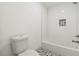 A modern bathroom with white tile, patterned flooring, and a sleek toilet at 2206 Loring Ct, Decatur, GA 30032